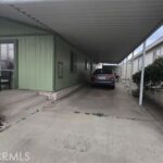 car in driveway with cover.