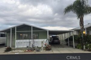 Exterior view of house with car in driveway for a listing at Ramrod Senior Housing.