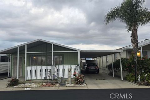 Exterior view of house with car in driveway for a listing at Ramrod Senior Housing.