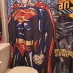 Super hero shower curt in in a kids bathroom.